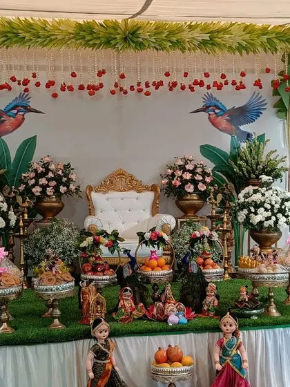 A complete view of the nature-themed gift display. The symmetrical arrangement of platters, dolls, and floral decorations creates a balanced and visually pleasing setup for the ceremony.