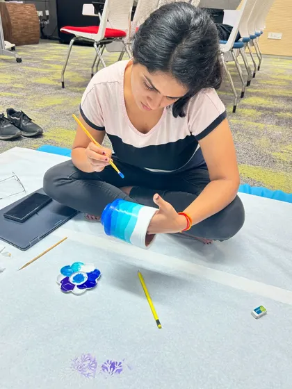A participant is fully absorbed in painting a terracotta vase during one of our workshops. These sessions are a great 3-hour escape into art.