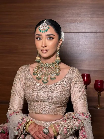 The complete look. The soft makeup complements the pastel outfit and the heavy jewelry perfectly.