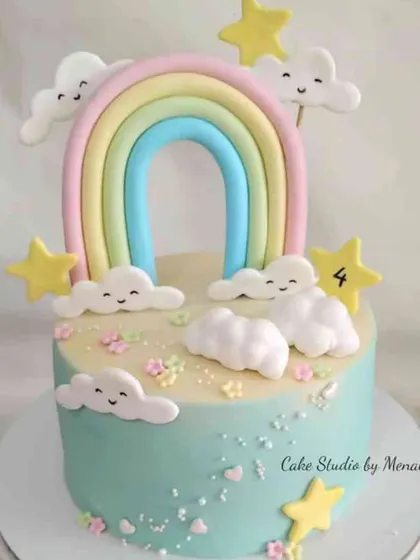A sweet and simple 4th birthday cake with a pastel rainbow and smiling clouds. This minimal fondant design is perfect for a cheerful and lighthearted celebration.