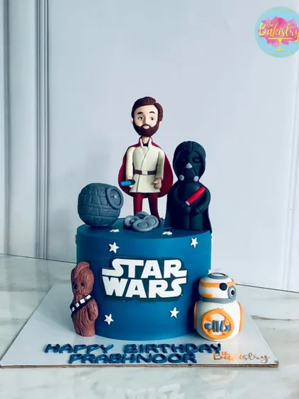 May the Force be with you! This epic Star Wars cake for Prabhnoor's birthday features iconic characters like Obi-Wan Kenobi, Darth Vader, Chewbacca, and BB-8.