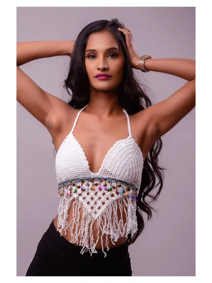 A pose that showcases the model's hair and the back details of the halter top.