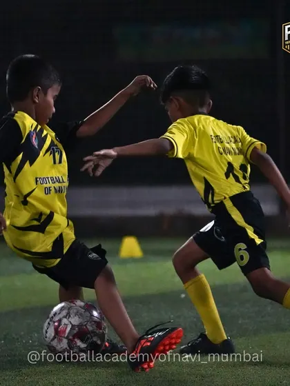 A player shields the ball from a defender in a competitive 1-on-1 situation. I teach players how to use their body to protect the ball and maintain possession.