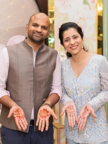 Even the men got in on the festive fun. My husband and I showing off our matching henna designs at our daughter's half birthday celebration.