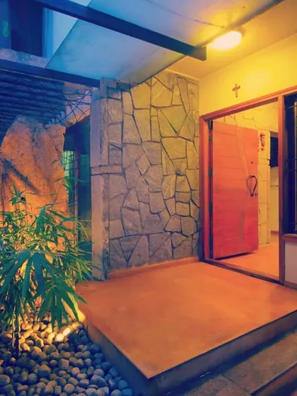 The entry to a home should be a transition from the outside world. Here, I used natural stone, a small pebble court with plants, and warm accent lighting to create a serene and welcoming entrance that sets a peaceful tone for the rest of the house.