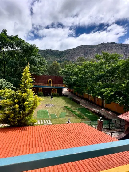 An overhead view of the sprawling lawns and beautiful property at our Nandi Hills resort, with the majestic hills in the background.