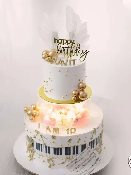 For the music lover, this two-tier piano-themed cake hits all the right notes. It features a keyboard, golden musical notes, and a beautiful light-up tier filled with flowers.