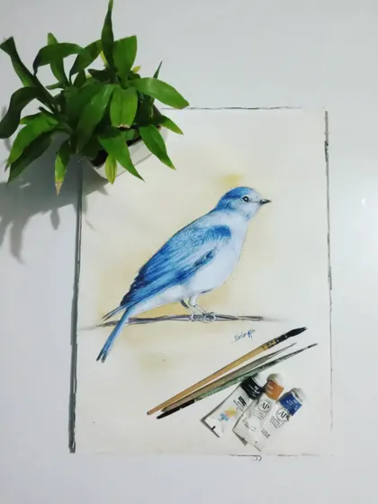 A beautiful bluebird painted in watercolor, shown with the tools of my trade. This nature study showcases my ability to capture delicate details and vibrant color with this medium.