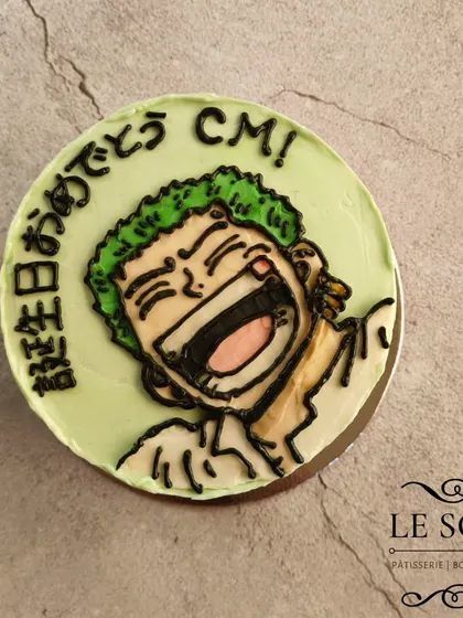 For the love of Zoro. This half-kg Vanilla Caramel cake is made entirely with buttercream, featuring a hand-piped portrait of the One Piece swordsman with Japanese text for "Happy Birthday".
