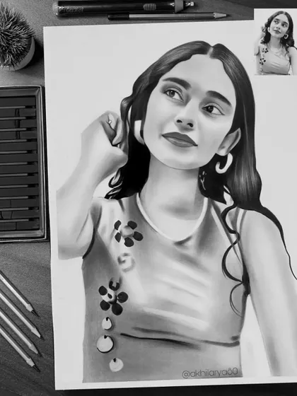 This A3 graphite sketch captures a thoughtful and elegant pose. The play of light and shadow on her face and hair adds a lot of depth to the drawing.