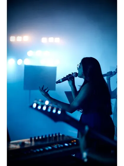 This is where I belong. A silhouette of me on stage, surrounded by the blue haze and stage lights, microphone in hand.