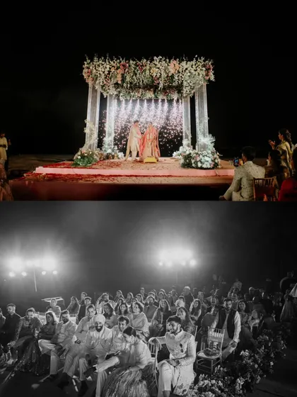 A dramatic night shot of the beach wedding ceremony, with fireworks illuminating the mandap as the couple completes their rituals.