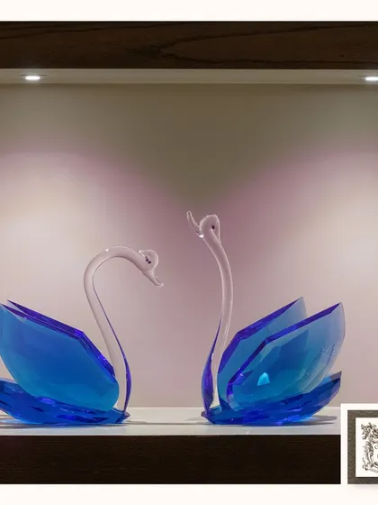 These stunning blue crystal swans, illuminated by soft downlighting, create a sense of serenity and timeless beauty. They are a perfect statement piece for a modern, sophisticated home.