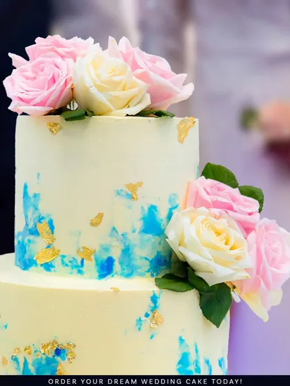 A close-up of the artistic blue watercolor strokes and fresh pink and white roses. It's a design that feels both modern and timeless.
