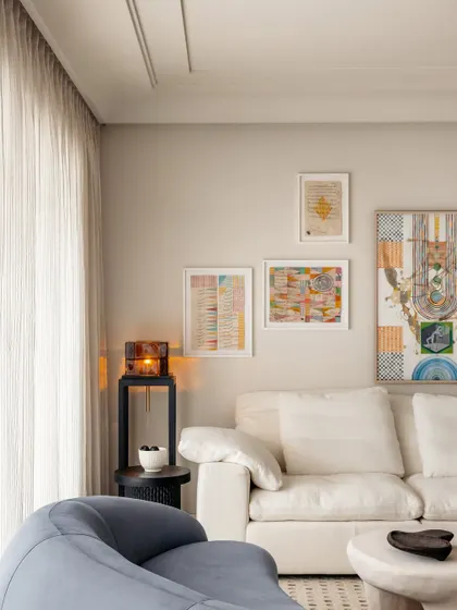 The living space was tailored for the family's dynamic lifestyle, with comfortable seating and a gallery wall of art that nurtures their love for connection and joy.