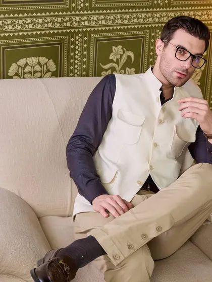 A more casual, intellectual styling of the four-pocket waistcoat. It's a piece that speaks of quiet luxury and thoughtful design.