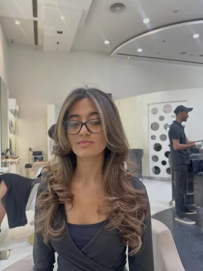 This straight-on view shows how the lighter pieces around the face brighten her whole look. A simple color refresh can make a huge difference.