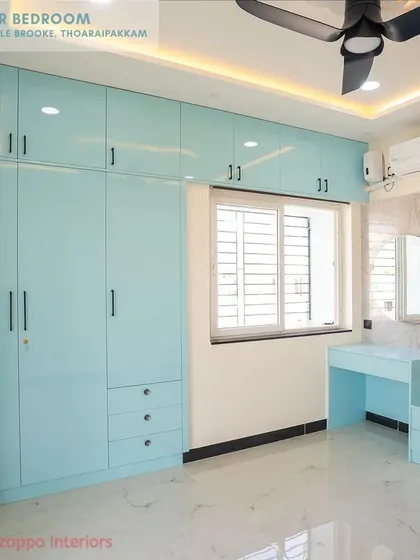 The master bedroom at Jain's Pebble Brooke features serene, light blue floor-to-ceiling wardrobes and a matching dressing table, creating a calm and cohesive space.