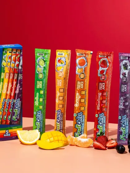 A colorful lineup of Fruitchill's different flavors. We styled this shot with corresponding fresh fruits against a bold, two-toned background to create a vibrant and organized showcase of the entire range.