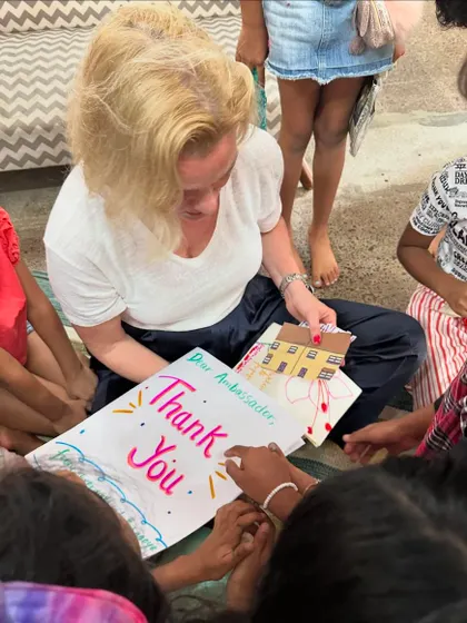 The children present the Norwegian Ambassador with a handmade thank you card. This simple act teaches them the importance of showing gratitude and appreciation.
