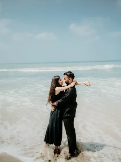 A romantic embrace in the waves. This photo captures the couple's adventurous spirit and their connection amidst the power and beauty of the ocean.