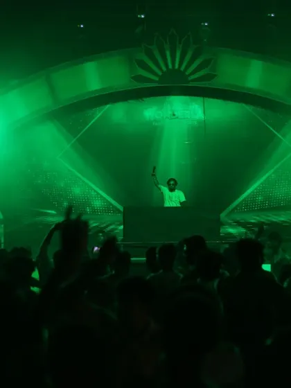 A wide shot of the stage under green lighting, showing my position relative to the large audience.