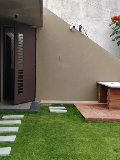 We transformed this terrace into a functional outdoor living area. The design incorporates a lush lawn, stone pavers, and a built-in brick seating area, creating a perfect space for relaxation that blends architecture with landscape.