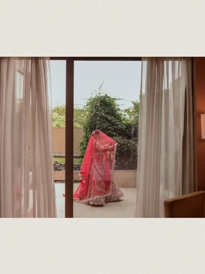 A shot of the bride through a doorway, creating a sense of anticipation.