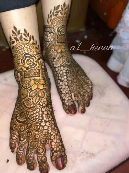 A close-up of a bridal foot design, showing how the pattern extends from the ankle to the toes.