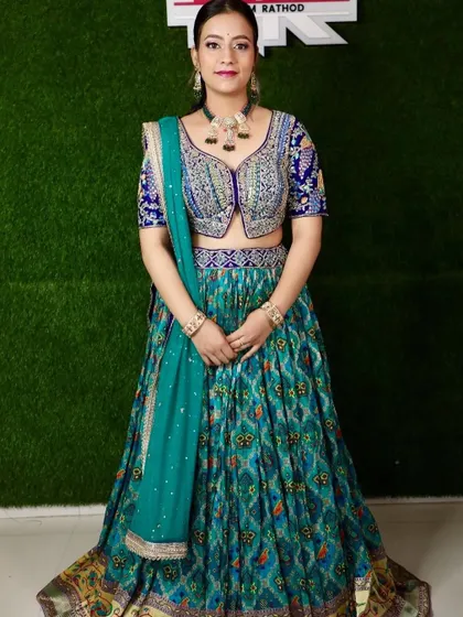 A full shot of the client in the teal printed lehenga, looking elegant and poised.