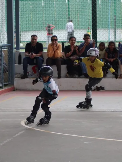Two young skaters race neck-and-neck in a competitive heat during our in-house skating competition.