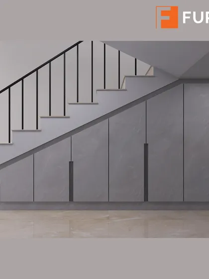 We transformed the often-unused space under the stairs into a massive storage unit with sleek, handleless doors, seamlessly blending it with the home's modern aesthetic.