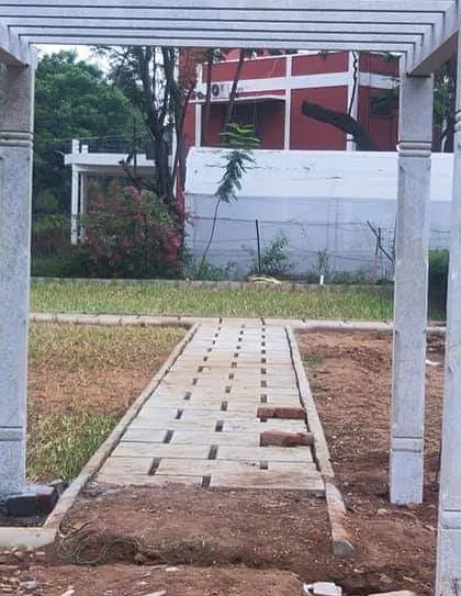 A simple stone pergola frame installed over an unfinished pathway. This will eventually be a beautiful, shaded walkway once the garden is complete.