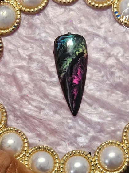 This dark, moody marble effect was created by a student. They've expertly blended black, green, and pink to create a galaxy-like design.