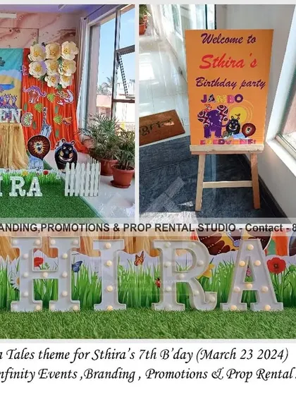 A fun and educational Tinga Tinga Tales theme for a 7th birthday. The decor features a colorful backdrop with characters from the show, a grass-covered table, and large marquee letters, creating a unique and artistic party atmosphere.