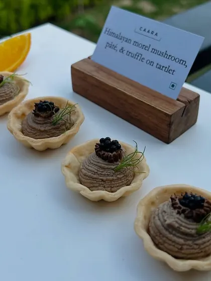 Our signature Himalayan morel mushroom, pâté, and truffle tartlets. This canapé highlights our commitment to using rare and exceptional regional ingredients, presented with an elegant touch for a truly gourmet bite.