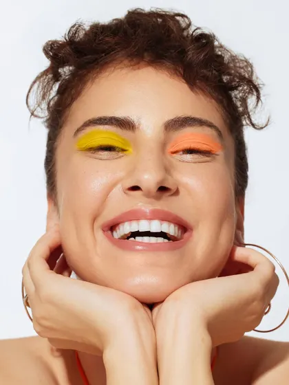 A beauty close-up where the focus is on the face. I kept the styling minimal to let the colorful makeup and the model's expression take center stage.