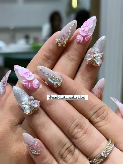 An example of our detailed 3D nail art. This set includes sculpted pink acrylic flowers and sparkling butterfly charms made of Swarovski crystals, all set on long, elegant stiletto extensions for a truly show-stopping effect.