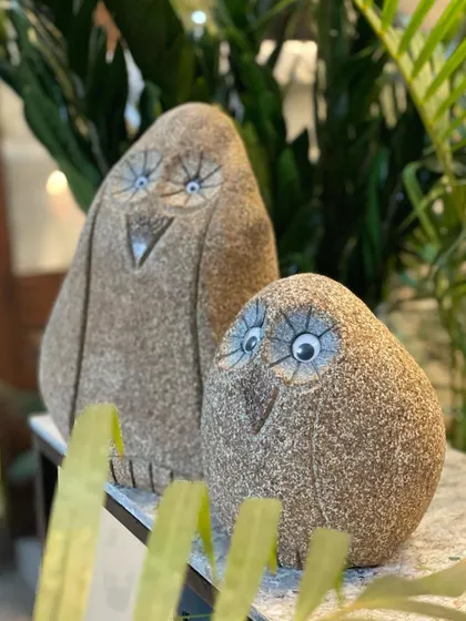 Our beloved 'Goobey' stone owls, peeking out from behind some plants. These natural rock pieces are full of character and make a wonderful, quirky gift for that special 'goobey' in your life.