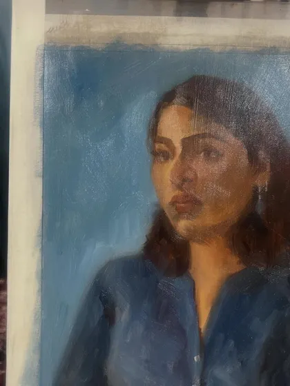 A side view of the finished portrait of Mirra, showing the texture of the oil on linen.