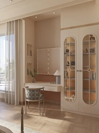 A closer look at the custom vanity and display unit, featuring arched glass doors that reflect the room's recurring design motif. The soft color palette ensures the furniture feels integrated and elegant.