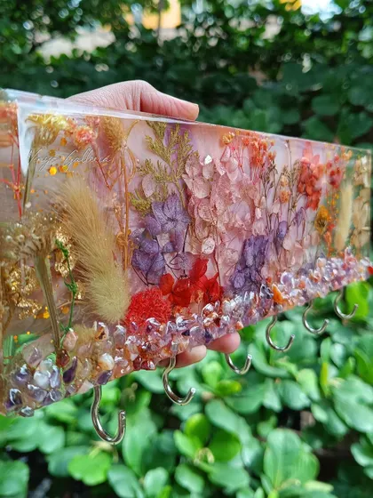 A side view of the floral key holder, showing the depth and vibrant colors of the preserved flowers.