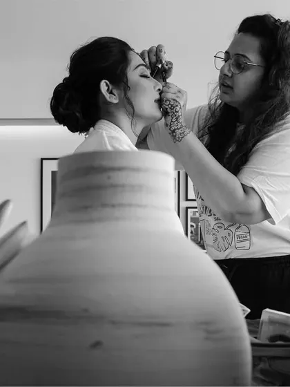 A behind-the-scenes look at a bride getting ready. This black and white collage captures the process, from makeup application to the final look against the Mumbai skyline.