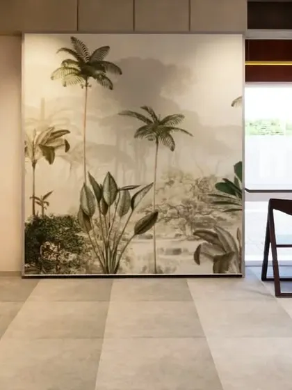 This concept for a 1BHK apartment explores the use of flexible furniture, like a folding bed, to augment the space. A sliding panel with a tropical mural conceals the bed when not in use, transforming the room from a bedroom into a spacious living area.