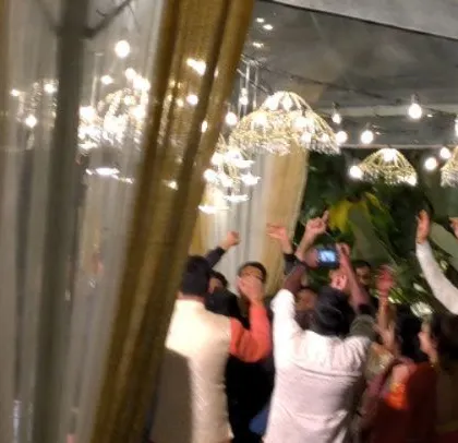Hands in the air! A moment of pure joy at the wedding reception.