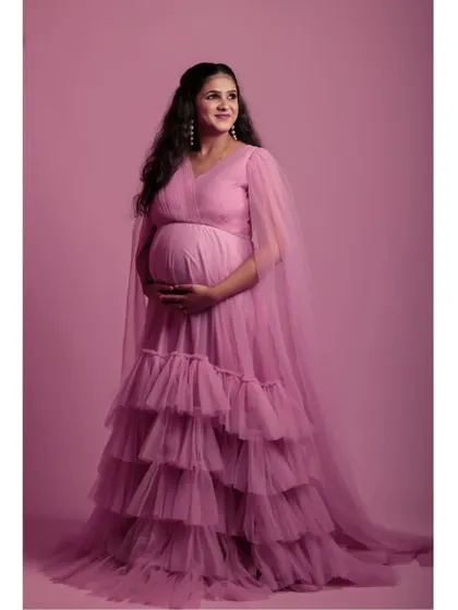 Another angle of the pink maternity gown, highlighting its elegant drape and comfortable fit, perfect for capturing your pregnancy glow.