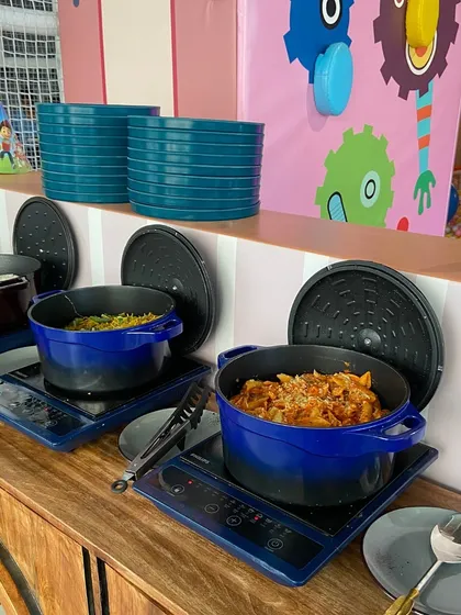 A peek at our party buffet setup, featuring hot dishes like pasta and noodles kept warm for guests.