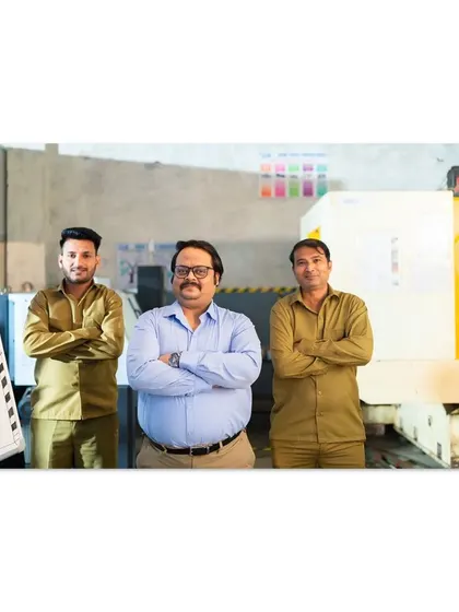 A commercial shot depicting a small business owner with his team in a factory setting. This image was created for a business loan campaign to tell a story of growth and partnership.