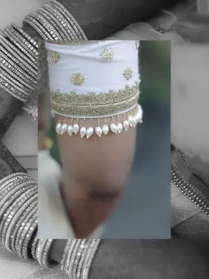 A black and white collage highlighting the delicate details of a bride's attire. The focus on the pearl tassels of her sleeve and her bangles creates an artistic and elegant image.