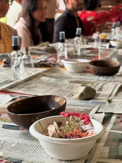 The raw materials for our eco-workshop: dried flowers, glass bottles, and natural ingredients.